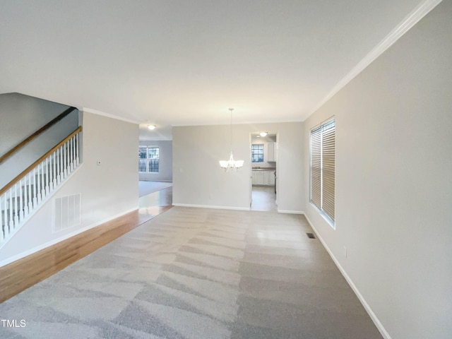 6701 Winding Arch Dr, Durham, NC 27713 - hallway with a chandelier, carpet, and ornamental molding