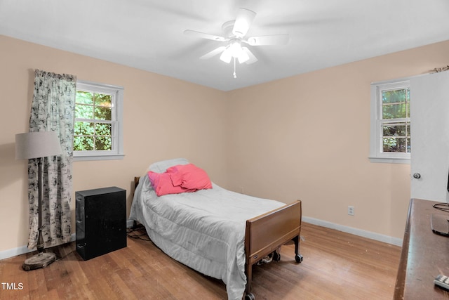 106 Lattimore Ln, Durham, NC 27713 - bedroom featuring wood finished floors, multiple windows, and ceiling fan