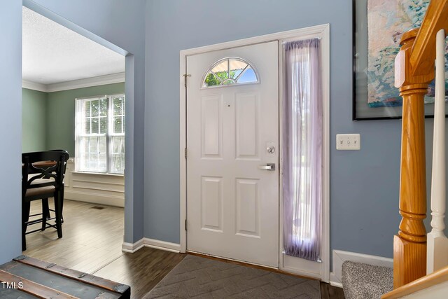 2302 Fordcrest Dr, Apex, NC 27502 - foyer with healthy amount of natural light, wood finished floors, and crown molding
