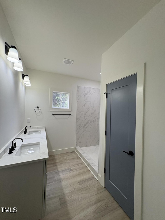 4511 Denfield St, Durham, NC 27704 - full bath with a shower stall, double vanity, and wood finished floors