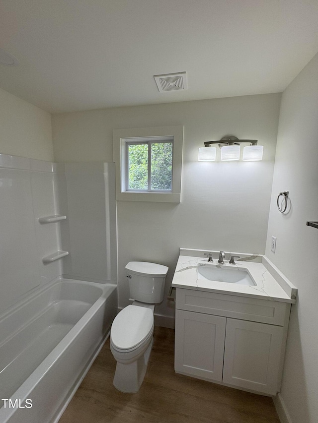 4511 Denfield St, Durham, NC 27704 - full bath with wood finished floors, vanity, and shower / bathtub combination