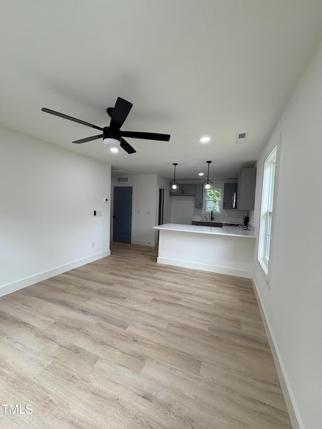 4511 Denfield St, Durham, NC 27704 - unfurnished living room featuring light wood finished floors, ceiling fan, and recessed lighting