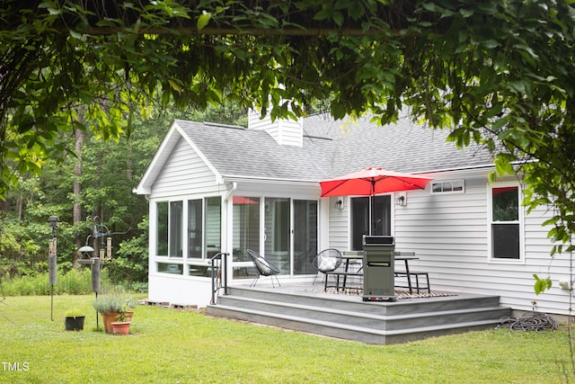 404 Denton St, Durham, NC 27713 - rear view of property featuring a sunroom, a deck, a shingled roof, a chimney, and a yard