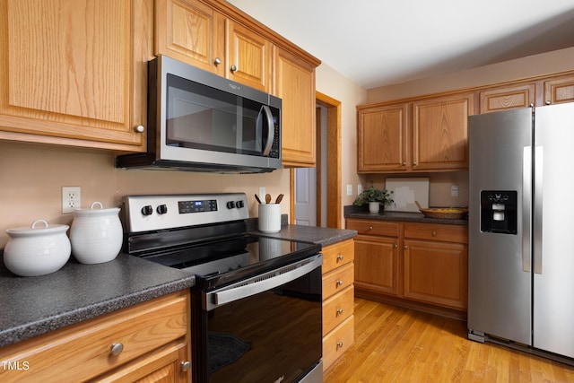404 Denton St, Durham, NC 27713 - kitchen with stainless steel appliances, dark countertops, and light wood-style floors