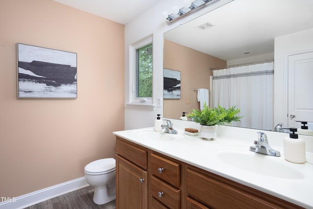 404 Denton St, Durham, NC 27713 - bathroom featuring double vanity and wood finished floors