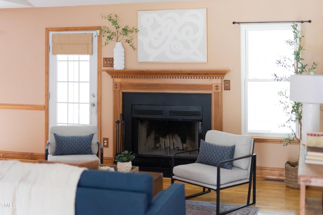 404 Denton St, Durham, NC 27713 - living area featuring wood finished floors, a fireplace, and plenty of natural light