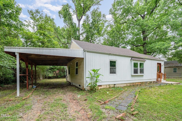 1401 Robinhood Rd, Durham, NC 27701 - view of home's exterior featuring an attached carport, dirt driveway, crawl space, and roof with shingles
