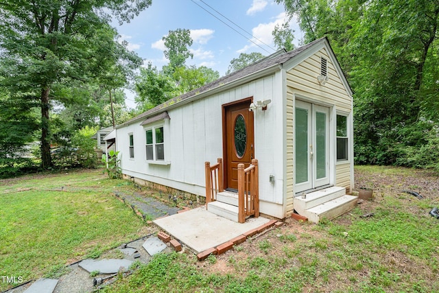 1401 Robinhood Rd, Durham, NC 27701 - view of front of property with entry steps, a front lawn, a shingled roof, and an outdoor structure
