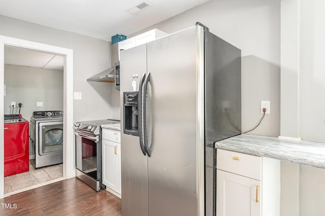1401 Robinhood Rd, Durham, NC 27701 - kitchen with stainless steel appliances, washing machine and dryer, dark wood finished floors, white cabinetry, and wall chimney exhaust hood