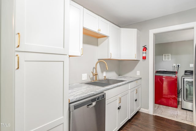 1401 Robinhood Rd, Durham, NC 27701 - kitchen featuring dishwasher, washer and dryer, dark wood-type flooring, and white cabinets