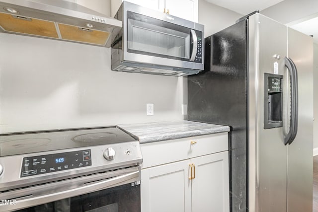 1401 Robinhood Rd, Durham, NC 27701 - kitchen with appliances with stainless steel finishes, extractor fan, light countertops, and white cabinetry