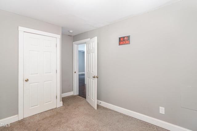 1401 Robinhood Rd, Durham, NC 27701 - unfurnished bedroom with light carpet and a closet