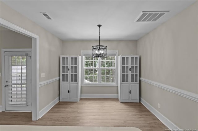507 Coxwold Pl, Fayetteville, NC 28311 - unfurnished dining area with wood finished floors and a chandelier