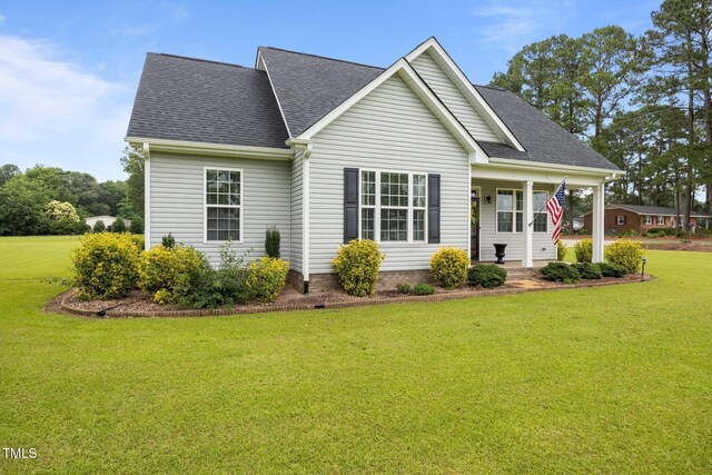 416 Fred Tew Rd, Dunn, NC 28334 - view of front facade with a front lawn, a shingled roof, and a porch