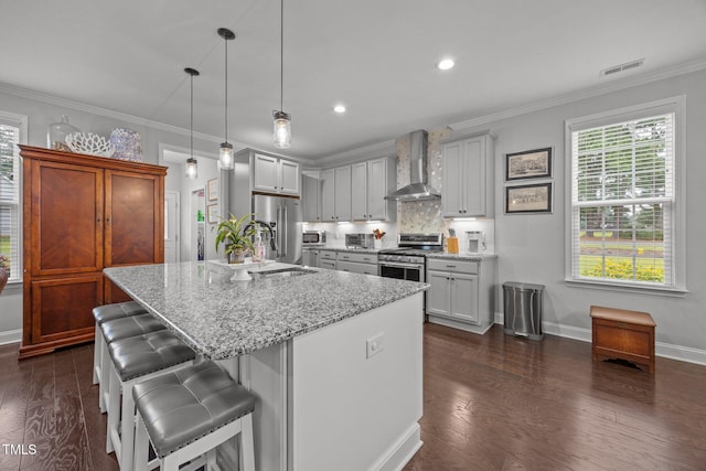 416 Fred Tew Rd, Dunn, NC 28334 - kitchen with wall chimney range hood, appliances with stainless steel finishes, light stone countertops, dark wood finished floors, and crown molding