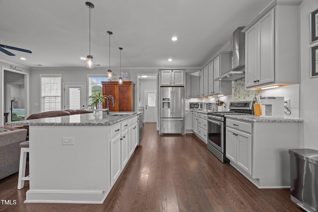 416 Fred Tew Rd, Dunn, NC 28334 - kitchen featuring appliances with stainless steel finishes, wall chimney exhaust hood, open floor plan, ceiling fan, and backsplash