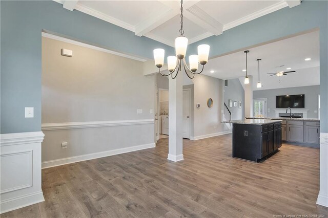 209 Nairn St, Fayetteville, NC 28311 - kitchen with open floor plan, beamed ceiling, a kitchen island, wood finished floors, and coffered ceiling