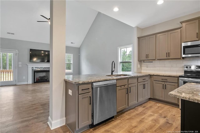 209 Nairn St, Fayetteville, NC 28311 - kitchen with appliances with stainless steel finishes, a peninsula, healthy amount of natural light, recessed lighting, and high vaulted ceiling