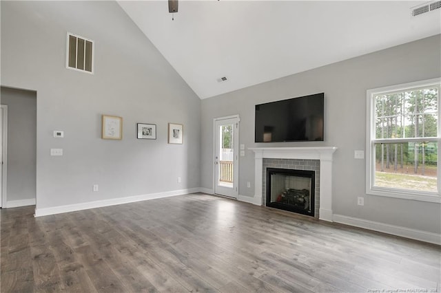 209 Nairn St, Fayetteville, NC 28311 - unfurnished living room featuring high vaulted ceiling, dark wood finished floors, a tile fireplace, and a ceiling fan
