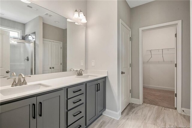 209 Nairn St, Fayetteville, NC 28311 - full bathroom featuring double vanity, a shower stall, and a walk in closet