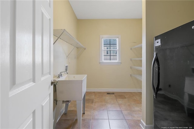 61 Fountain Park Cir, Spring Lake, NC 28390 - washroom with washer hookup and light tile patterned floors
