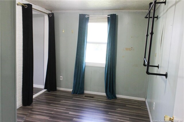 411 Rainey Dr, Spring Lake, NC 28390 - spare room featuring wood finished floors, ornamental molding, and a textured ceiling
