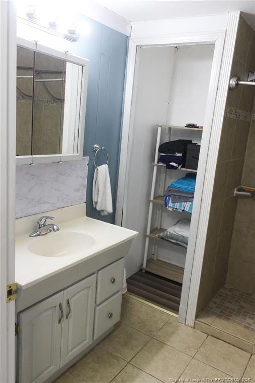 411 Rainey Dr, Spring Lake, NC 28390 - bathroom with vanity, tiled shower, and tile patterned flooring