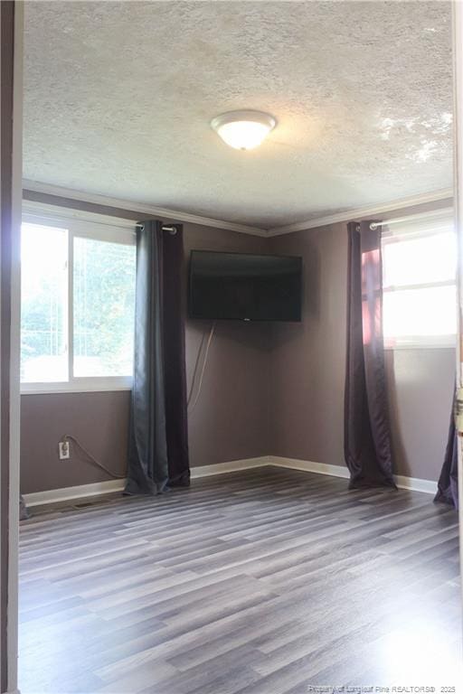 411 Rainey Dr, Spring Lake, NC 28390 - empty room with a textured ceiling, wood finished floors, and crown molding