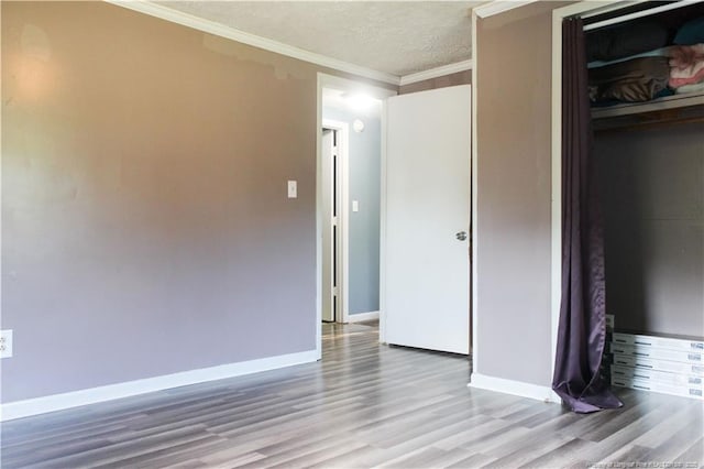 411 Rainey Dr, Spring Lake, NC 28390 - unfurnished bedroom with light wood-style floors, crown molding, a closet, and a textured ceiling