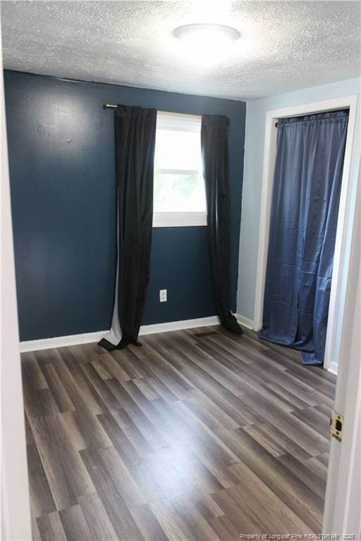 411 Rainey Dr, Spring Lake, NC 28390 - empty room with a textured ceiling and wood finished floors