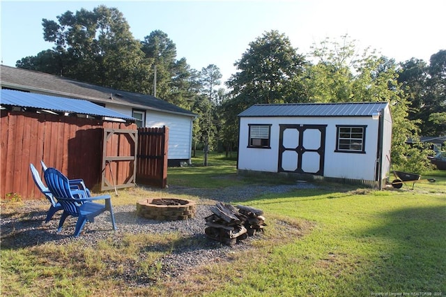 411 Rainey Dr, Spring Lake, NC 28390 - view of grassy yard with an outdoor fire pit and a shed