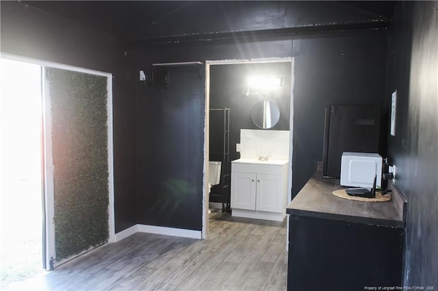 411 Rainey Dr, Spring Lake, NC 28390 - unfurnished bedroom featuring light wood finished floors and a sink