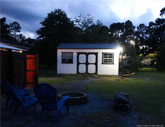 411 Rainey Dr, Spring Lake, NC 28390 - view of shed featuring a fire pit
