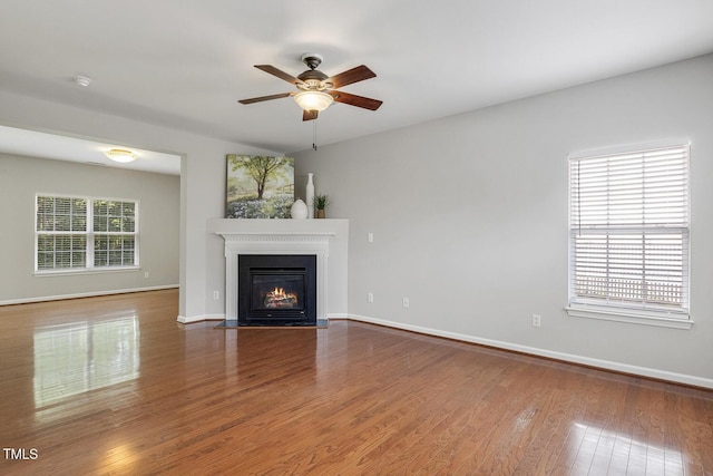 160 Chandler Springs Dr, Holly Springs, NC 27540 - unfurnished living room featuring ceiling fan, a fireplace with flush hearth, and wood finished floors