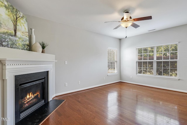 160 Chandler Springs Dr, Holly Springs, NC 27540 - unfurnished living room featuring a glass covered fireplace, a ceiling fan, and wood finished floors
