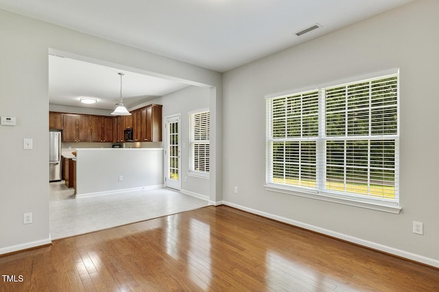 160 Chandler Springs Dr, Holly Springs, NC 27540 - unfurnished living room featuring baseboards and light wood-style floors