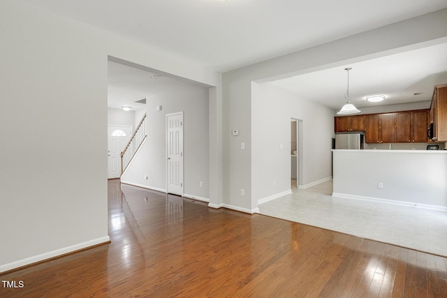 160 Chandler Springs Dr, Holly Springs, NC 27540 - unfurnished living room with wood finished floors and stairs
