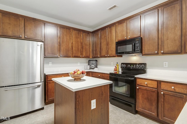 160 Chandler Springs Dr, Holly Springs, NC 27540 - kitchen with black appliances, light countertops, a center island, and light tile patterned floors