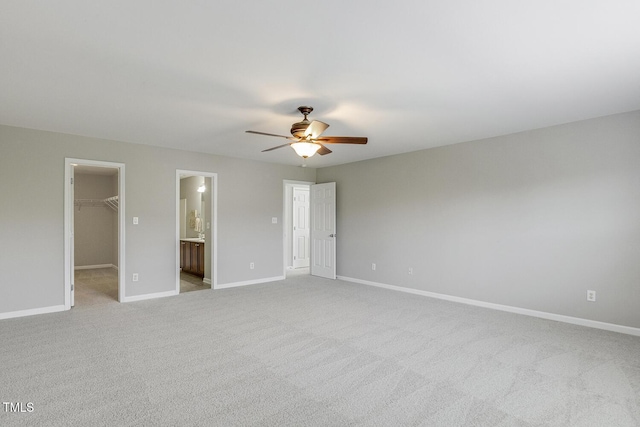 160 Chandler Springs Dr, Holly Springs, NC 27540 - unfurnished bedroom featuring a walk in closet, a closet, carpet flooring, a ceiling fan, and connected bathroom