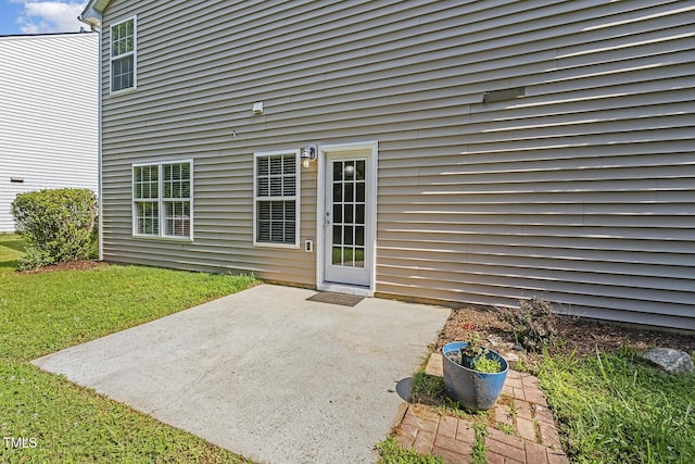 160 Chandler Springs Dr, Holly Springs, NC 27540 - view of exterior entry with a patio and a lawn