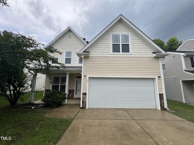 3852 Cane Garden Dr, Raleigh, NC 27610 - traditional-style house featuring an attached garage, concrete driveway, a front yard, and stone siding