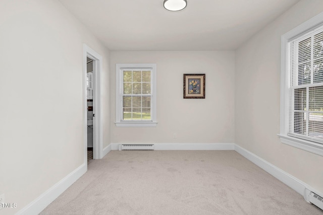 407 W Pippen St, Whitakers, NC 27891 - unfurnished room featuring a baseboard heating unit, light carpet, and healthy amount of natural light