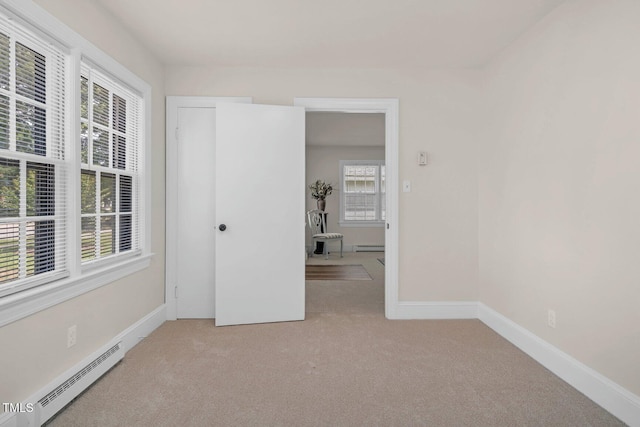 407 W Pippen St, Whitakers, NC 27891 - spare room with baseboard heating, light carpet, and a baseboard heating unit