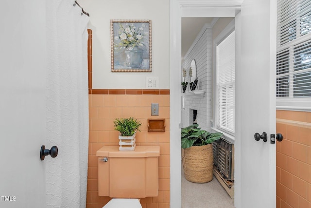 407 W Pippen St, Whitakers, NC 27891 - full bath featuring tile walls, a wainscoted wall, healthy amount of natural light, and a shower with curtain