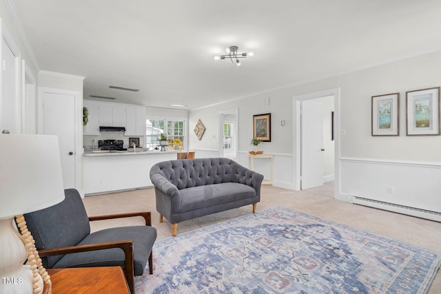 407 W Pippen St, Whitakers, NC 27891 - living area with a wainscoted wall, light carpet, and a baseboard heating unit