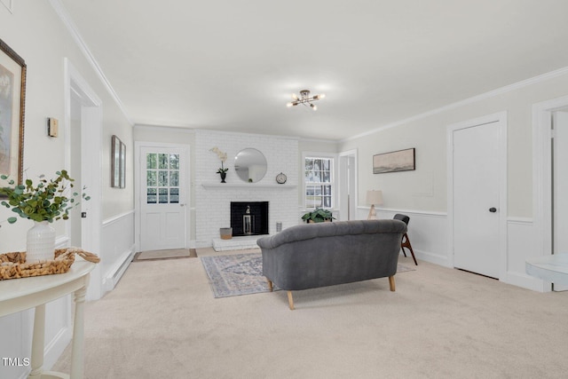 407 W Pippen St, Whitakers, NC 27891 - carpeted living area with crown molding, a brick fireplace, a wainscoted wall, and a decorative wall