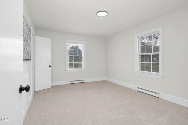 407 W Pippen St, Whitakers, NC 27891 - spare room featuring a baseboard radiator and carpet