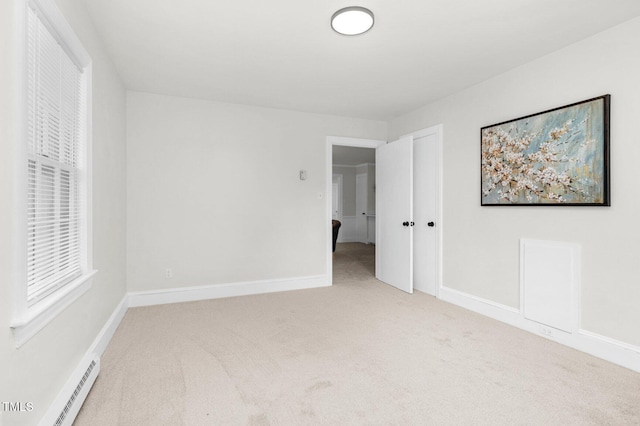 407 W Pippen St, Whitakers, NC 27891 - carpeted empty room with baseboard heating and baseboards
