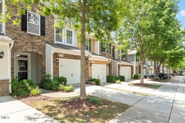 1213 Silver Beach Way, Raleigh, NC 27606 - multi unit property with stone siding, an attached garage, and driveway