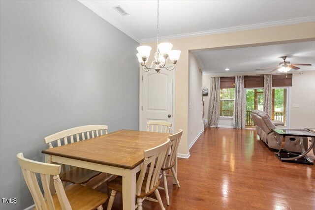 1213 Silver Beach Way, Raleigh, NC 27606 - dining space with crown molding, a chandelier, wood finished floors, and ceiling fan
